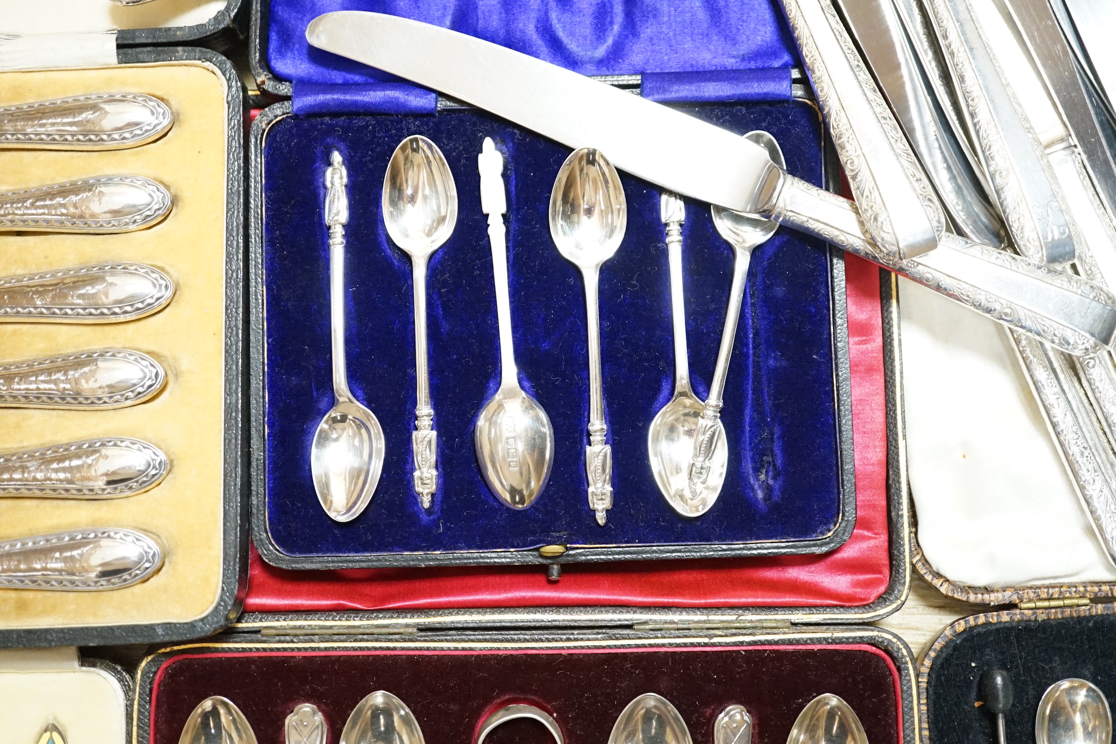 A cased set of six George V silver and polychrome enamel coffee spoons, Barker Brothers Silver Ltd, Birmingham, 1932, four other cased sets including teaspoons and tea knives and seventeen assorted Towle sterling handled